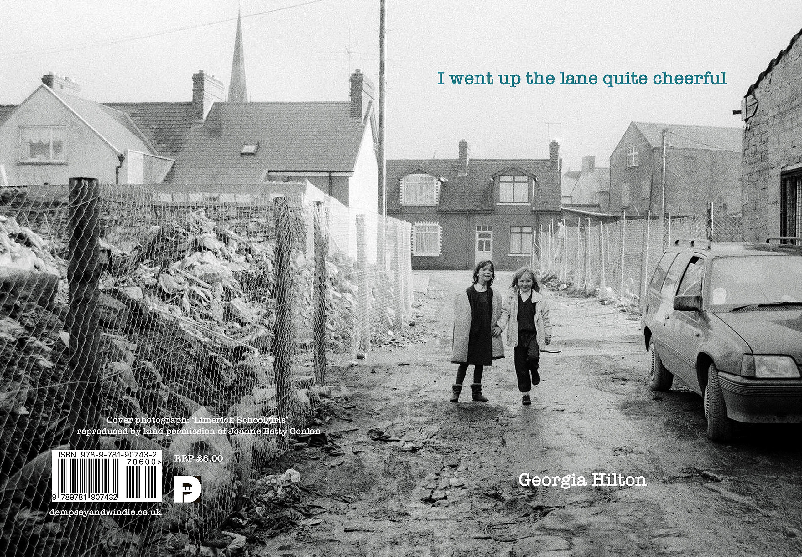 Book cover of poetry pamphlet showing two young primary school girls walking up a muddy street in the early 1990s with houses in the background and rubble behind fencing to their left.